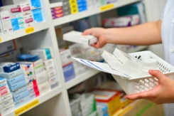 Stock photo of anonymous pharmacist handling drugs.